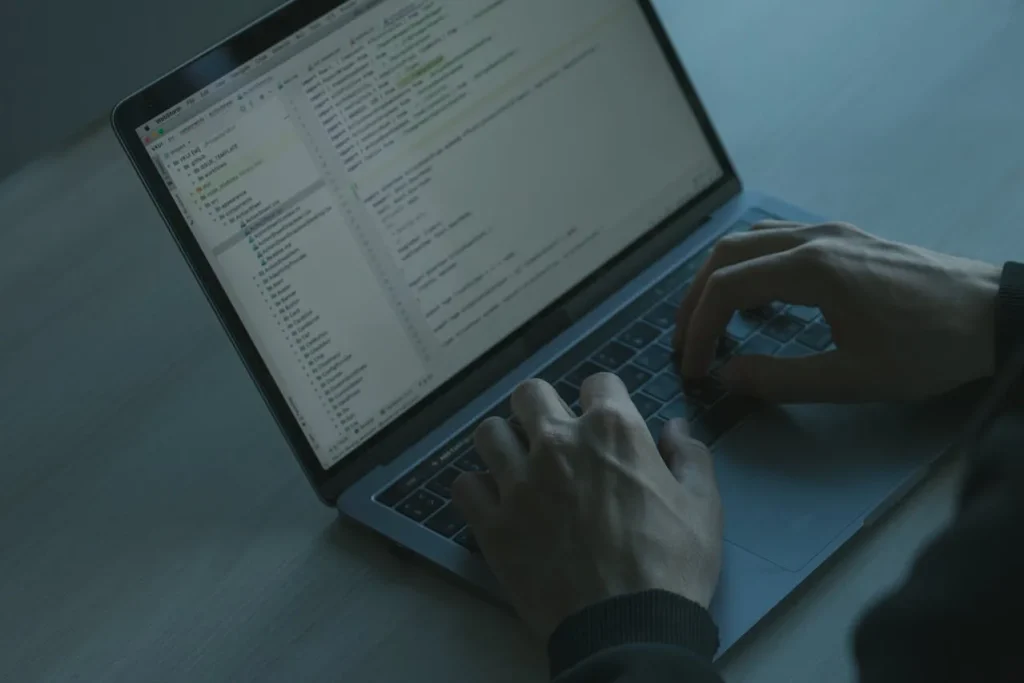 man coding in his laptop
